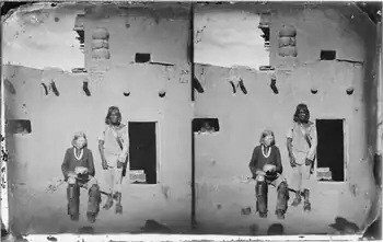The man seated left is a Zuni with albinism. The Zuni people and other indigenous tribes of the American Southwest have a very high incidence of albinism..mw-parser-output cite.citation{font-style:inherit;word-wrap:break-word}.mw-parser-output .citation q{quotes:"\"""\"""'""'"}.mw-parser-output .citation:target{background-color:rgba(0,127,255,0.133)}.mw-parser-output .id-lock-free a,.mw-parser-output .citation .cs1-lock-free a{background:url("//upload.wikimedia.org/wikipedia/commons/6/65/Lock-green.svg")right 0.1em center/9px no-repeat}.mw-parser-output .id-lock-limited a,.mw-parser-output .id-lock-registration a,.mw-parser-output .citation .cs1-lock-limited a,.mw-parser-output .citation .cs1-lock-registration a{background:url("//upload.wikimedia.org/wikipedia/commons/d/d6/Lock-gray-alt-2.svg")right 0.1em center/9px no-repeat}.mw-parser-output .id-lock-subscription a,.mw-parser-output .citation .cs1-lock-subscription a{background:url("//upload.wikimedia.org/wikipedia/commons/a/aa/Lock-red-alt-2.svg")right 0.1em center/9px no-repeat}.mw-parser-output .cs1-ws-icon a{background:url("//upload.wikimedia.org/wikipedia/commons/4/4c/Wikisource-logo.svg")right 0.1em center/12px no-repeat}.mw-parser-output .cs1-code{color:inherit;background:inherit;border:none;padding:inherit}.mw-parser-output .cs1-hidden-error{display:none;color:#d33}.mw-parser-output .cs1-visible-error{color:#d33}.mw-parser-output .cs1-maint{display:none;color:#3a3;margin-left:0.3em}.mw-parser-output .cs1-format{font-size:95%}.mw-parser-output .cs1-kern-left{padding-left:0.2em}.mw-parser-output .cs1-kern-right{padding-right:0.2em}.mw-parser-output .citation .mw-selflink{font-weight:inherit}Yi, Z; Garrison, N; Cohen-Barak, O; Karafet, TM; King, RA; Erickson, RP; Hammer, MF; Brilliant, MH (January 2003). "A 122.5-kilobase deletion of the P gene underlies the high prevalence of oculocutaneous albinism type 2 in the Navajo population". American Journal of Human Genetics. 72 (1): 62–72. doi:10.1086/345380. PMC 420013. PMID 12469324.